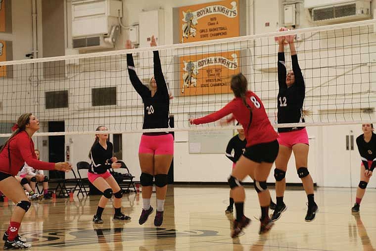 Kailee Harris and Taylor Freeman go for a block against River View and narrowly miss.