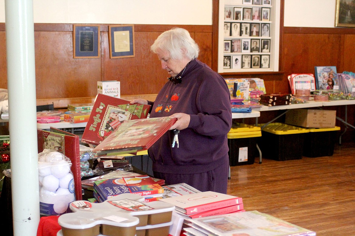 &lt;p&gt;&lt;strong&gt;Linda Zimmer looks over books being sold at the Retired Seniors Volunteer Program book and gift fair.&lt;/strong&gt;&lt;/p&gt;