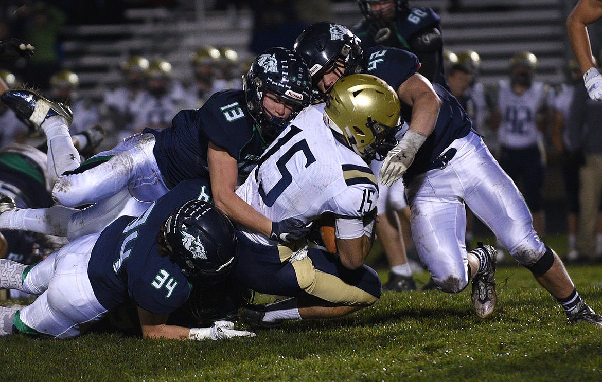 &lt;p&gt;Glacier defenders Cole Crosby (34), Sam Barber (13), and Jared Brenden (42) slam Missoula Big Sky quarterback Levi Janacaro to the ground. (Aaric Bryan/Daily Inter Lake)&lt;/p&gt;