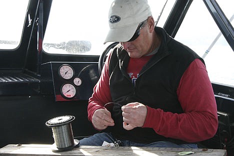 &lt;p&gt;Jeff Smith rigs a lure on Lake Coeur d'Alene last week. Mini squids drew a couple hits from chinook salmon.&lt;/p&gt;