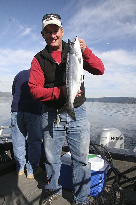 &lt;p&gt;Jeff Smith, owner and guide at Fins &amp; Feathers tackle shop, holds up a Lake Coeur d'Alene chinook salmon last week.&lt;/p&gt;