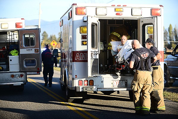 &lt;p&gt;Kalispell firefighters Jason Schwaiger and Don Thibert load an injured man into an ambulance on Wednesday at the scene of an explosion and fire on Rose Crossing Road in the Helena Flats area. The Evergreen and Creston fire departments as well as the Flathead County Sheriff&#146;s Department responded to the scene. At least two people were injured.&lt;/p&gt;&lt;div&gt;&#160;&lt;/div&gt;