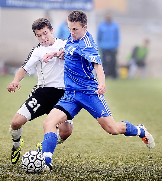 <p>Stillwater senior Julian Emond (14) kicks the ball under pressure from Yellowstone County Christian Homeschool junior Daniel Jacobsen during the 2013 MCAA Soccer Tournament on Saturday, October 26, in Kalispell. Stillwater won the match up in overtime 6 to 4. (Brenda Ahearn/Daily Inter Lake)</p>