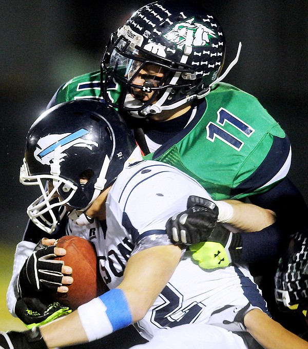 <p>Glacier junior Tucker Rauthe (11) takes down Great Falls senior running back Brad Humphreys (32) during the first half of Fridays Class AA football game at Legends Stadium. (Brenda Ahearn/Daily Inter Lake)</p>