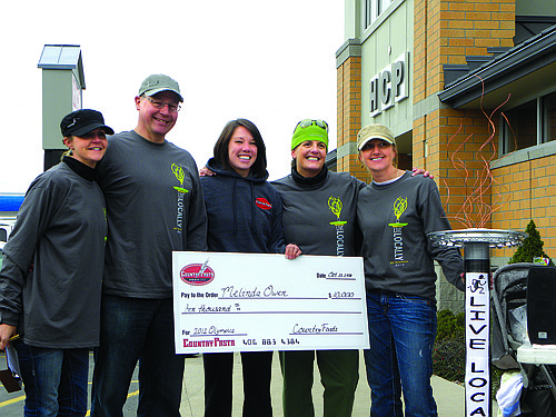 Country Pasta, sponsors of the Live Locally 5k, present Melinda Owen with a $10,000 check Saturday at the race. Owen will train at the Olympic Training Center in San Diego this year and compete for a spot on the 2012 U.S. Olympic Team. Above, race organizers Sarah Hartsoch Bird and Heather Knutson, and Country Pasta owners Fred and Amy Kellogg pose with Owen and the big check.