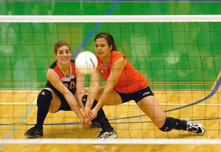 Flathead High seniors Jaimee Zorn and Mary Allen go for the dig in Tuesday’s crosstown volleyball meeting at Glacier High.