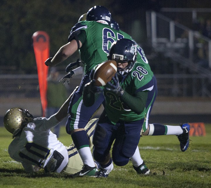 <p>Glacier junior running back Aaron Mitchell (28) dives into the
end zone for the Wolfpack's second touchdown Friday night at
Legends Stadium.</p>