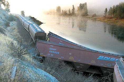 Jennifer McBride/Valley Press A train derailed, dropping 19 cars carrying soybeans along the Clark Fork River Oct. 22.