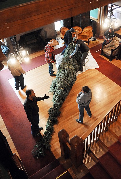 <p>Conrad Mansion Executive Director Mike Kofford, lower left,
along with museum staff and crew from the Snow Line Tree Company
carefully lay out the 18 foot Grand Fir tree on Friday, October 21,
as they prepare for the annual decorating of the mansion.</p>