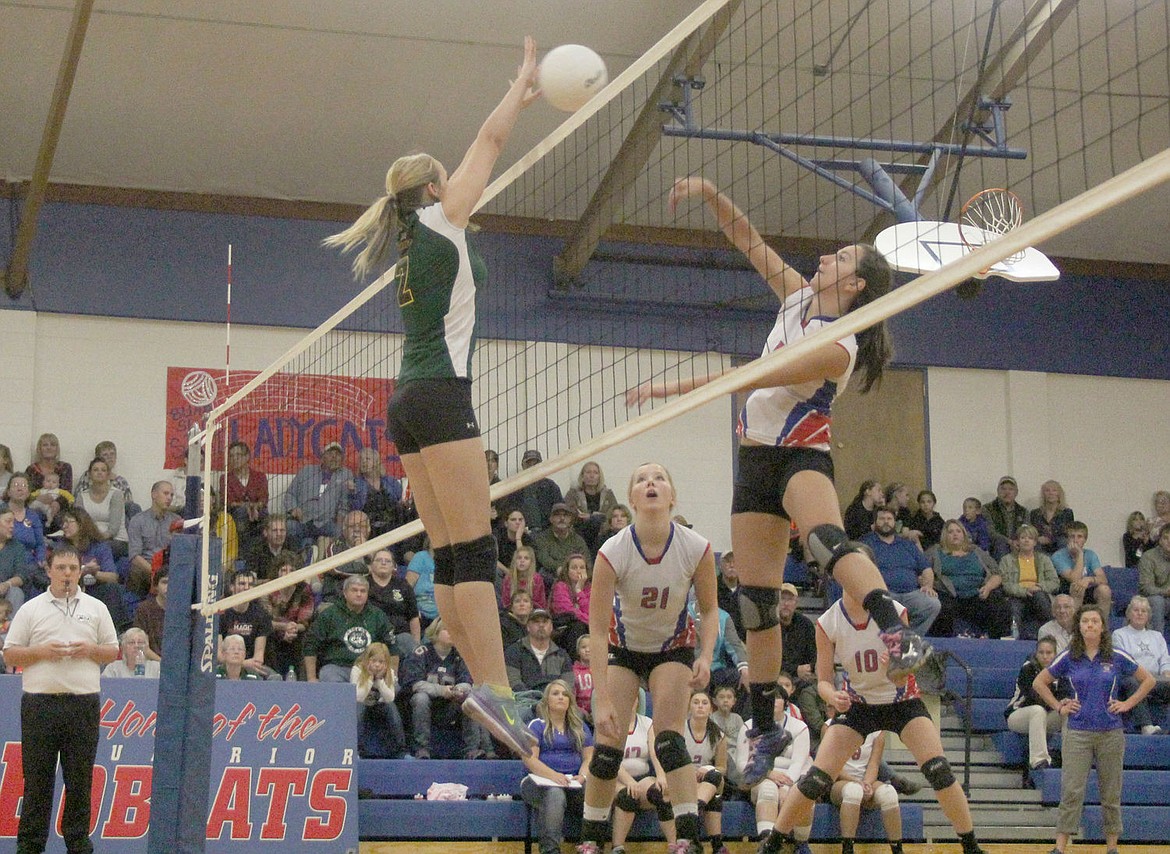 &lt;p&gt;Danielle Ewounik spikes the ball on a St. Regis defender during a match last week.&lt;/p&gt;