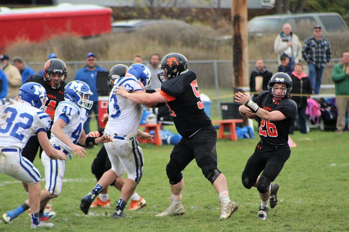 &lt;p&gt;Eureka running back Matthew Anderson (26) heads upfield for a first down around a block by tackle Owen Davis during Saturday&#146;s Class B football playoff game versus Malta in Eureka. Anderson had touchdown runs of five and 16 yards. (Photo courtesy Carmen Davis)&lt;/p&gt;