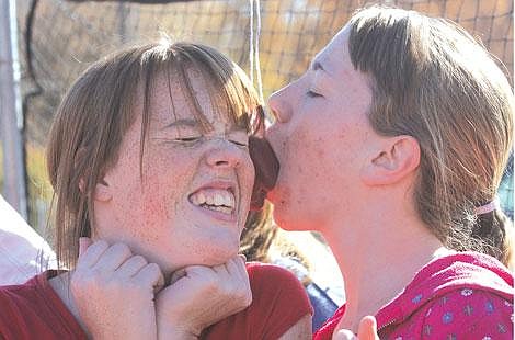 Jennifer McBride/Valley Press Saisha Wood, left, and Ashley Thompson, right, got close and comfortable Friday afternoon during an apple eating competition in celebration of Red Ribbon Week. The Plains School System participated in a week&#146;s worth of events promoting the theme: &#147;Stomp out Drugs.&#148;