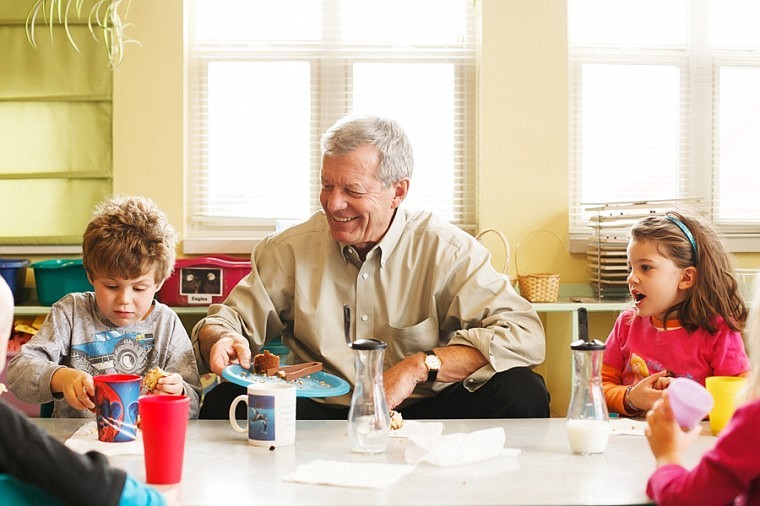 &lt;p&gt;Sen. Max Baucus serves muffins to students Morgan Guffin, 5, and Sarah Espinoza, 4, Tuesday afternoon during snack time at Discovery Developmental Center in Kalispell.&lt;/p&gt;