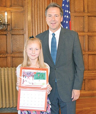 <p>On Wednesday, October 21, Governor Steve Bullock honored thirteen Montana 3rd, 4th, 5th, and 6th grade students who submitted winning posters for the 2016 Montana Energy Calendar. Libby student Sophia Kim received a Governor's Citation. Pictured below are (from left to right) student Sophia Kim and Governor Steve Bullock. The topic of the calendar is "Electrical Safety Inside and Outside!"</p>