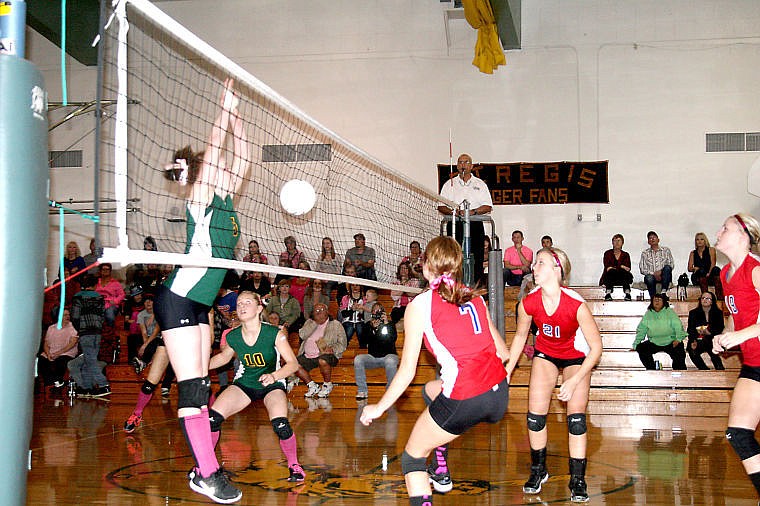 &lt;p&gt;Junior Gabby Moeller of the St. Regis Lady Tigers leaps to block the ball and senior Michelle Smith and junior Jordan Mueller of the Superior Lady Bobcats brace to recover the net shot. St. Regis played Superior on their last game before the regional tournament on Thursday.&lt;/p&gt;