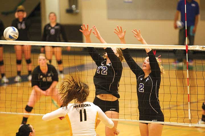 Big Bend freshman middle blocker Brooke Bowers (12) and sophomore outside hitter Katie Reeder (2) attempt to block a shot from Walla Walla freshman outside hitter Kiendra Chester (11) Wednesday night.