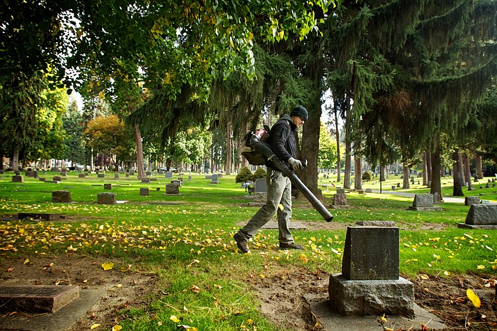 &lt;p&gt;JEROME A. POLLOS/Press Nick Goodwin, with the City if Coeur d'Alene, clears leaves and pine needles Wednesday from the headstones at Forest Cemetery.&lt;/p&gt;