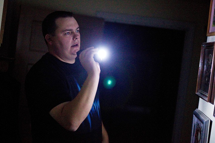 &lt;p&gt;Mike Beck, with the International Paranormal Reporting Group, views photographs in the basement hallway of the Roosevelt Inn.&lt;/p&gt;