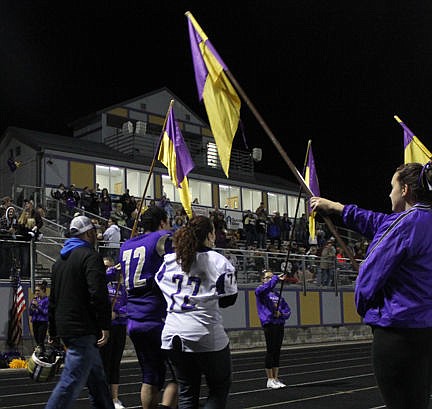 &lt;p&gt;Polson&#146;s Kaleb Auld and his family walk below a canopy of flags during Friday&#146;s halftime ceremony. Below right: Ronan Justin Krahn makes a quick pitch Friday.&lt;/p&gt;