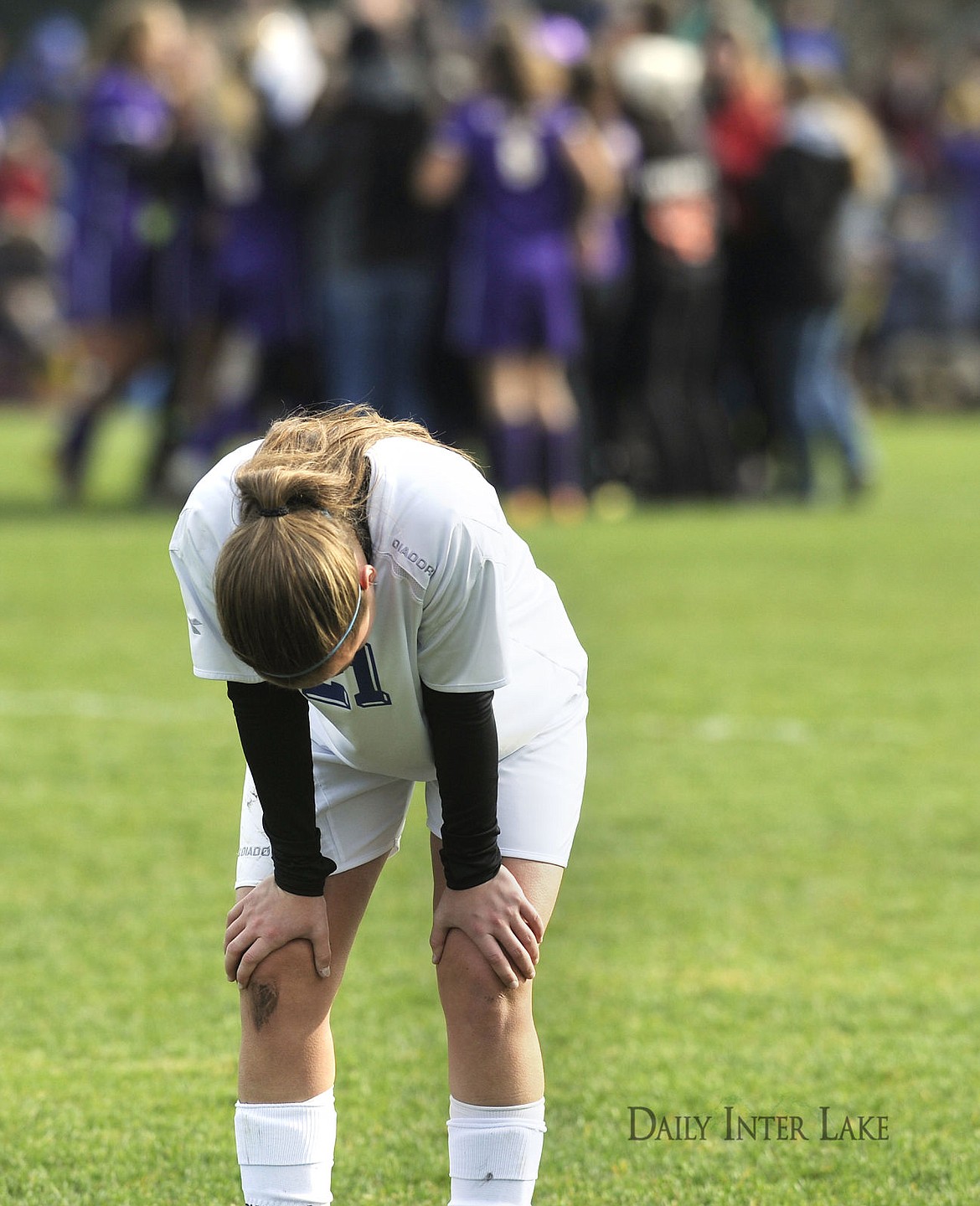 <p>Columbia Falls' Ellie Johnson walks off the field as Laurel celebrates their 2-1 victory in the Montana Class A Soccer Championship in Columbia Falls on Saturday. (Aaric Bryan/Daily Inter Lake)</p>