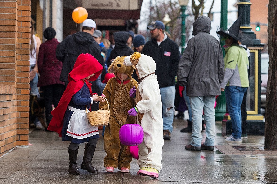 &lt;p&gt;From left, Callahan Kuhlmann, 5, dressed as Little Red Riding Hood and twins Lily and Dahlia Kramer, 5, dressed as puppies, compare their candy haul Saturday while hundreds trick-or-treat at downtown businesses near Sherman Avenue in Coeur d&#146;Alene.&lt;/p&gt;