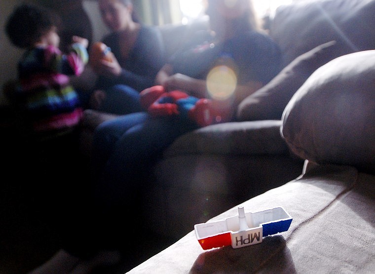 TARYN HAYNES, 4, plays with a Mr. Potato Head toy with her mom Tawny while Genny Graham looks on. &#147;They&#146;re little pieces of their daddy,&#148; Tawny says of her children. &#147;You feel like you still have a little piece of him with you.&#148;