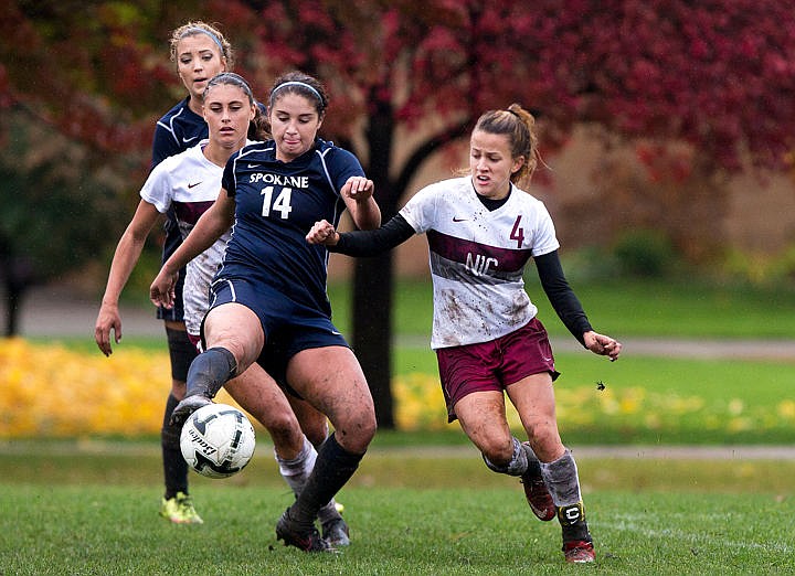 &lt;p&gt;Community Colleges of Spokane's Emily Carrell (14) tips the ball out in front of her as Emily Aspden (4) of North Idaho watches on Wednesday, Oct. 26, 2016 at North Idaho College.&lt;/p&gt;