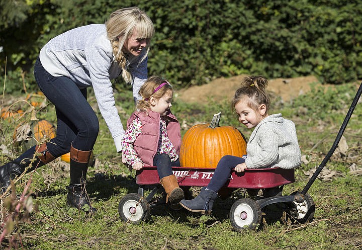 &lt;p&gt;Cousins Kendal Buttrey, center, and Olivia Peterson are pushed around in a wheelbarrow by Chauntae Peterson Wednesday morning, Oct. 12, 2016 after selecting a pumpkin at Prairie Home Farm.&lt;/p&gt;