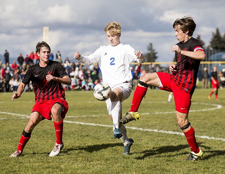 &lt;p&gt;Coeur d'Alene's Dempsey Brewer battles for the ball while draped by two Boise High School defenders during Saturday's 5A Championship game on Oct. 22, 2016 at Coeur d'Alene High School.&lt;/p&gt;