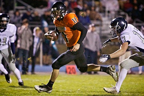 &lt;p&gt;Post Falls High's Taylor Valente sprints between two Lake City defenders as he eyes the goal line.&lt;/p&gt;