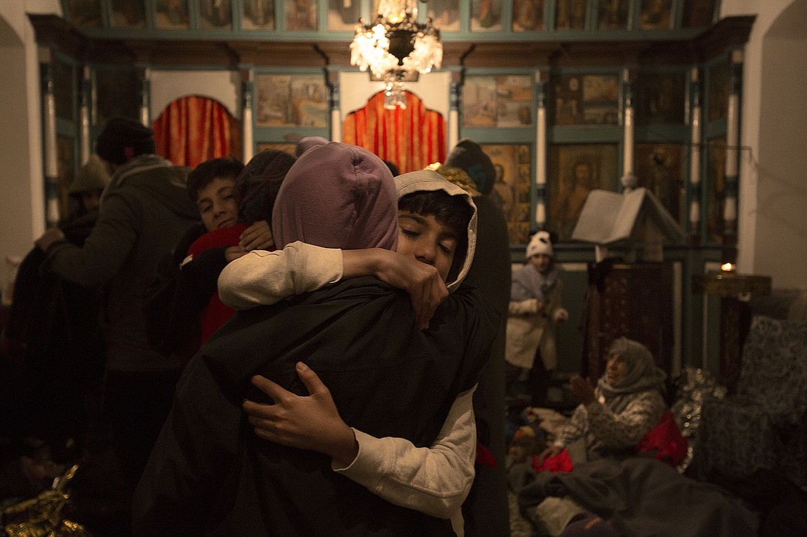 &lt;p&gt;Two Syrian boys who were aboard the wooden boat that sank earlier in the day embrace Wednesday evening after reuniting inside a church in Molyvos, Lesbos, Greece.&lt;/p&gt;