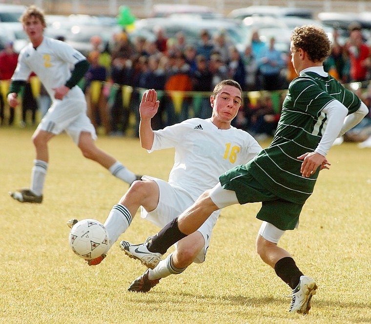 Whitefish's Matty McCrone gets a leg on Billings Central's Cory Miller's kick in the first half of the State A Championship in Whitefish Saturday afternoon.