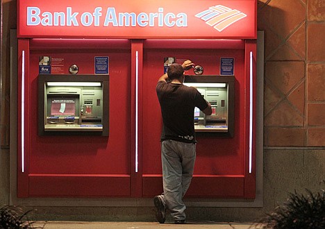 &lt;p&gt;This photo taken Oct. 14, 2011, shows a customer at a Bank of America ATM in Hialeah, Fla. Bank of America Corp. is scrapping its plans to charge a $5 monthly debit card fee. The bank's decision to drop the fee came after a roar of customer outrage in recent weeks over the fee. (AP Photo/Alan Diaz)&lt;/p&gt;