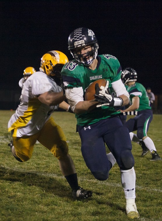 <p>Patrick Cote/Daily Inter Lake Glacier junior line backer Todd Ogden (13) runs back an interception for a touchdown Friday night during Glacier's playoff victory over Helena Capital at Legends Stadium. Friday, Nov. 2, 2012 in Kalispell, Montana.</p>