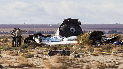 &lt;p&gt;Law enforcement officers take a closer look at the wreckage near the site where a Virgin Galactic space tourism rocket, SpaceShipTwo, exploded and crashed in Mojave, Calif. on Saturday.&#160;&lt;/p&gt;