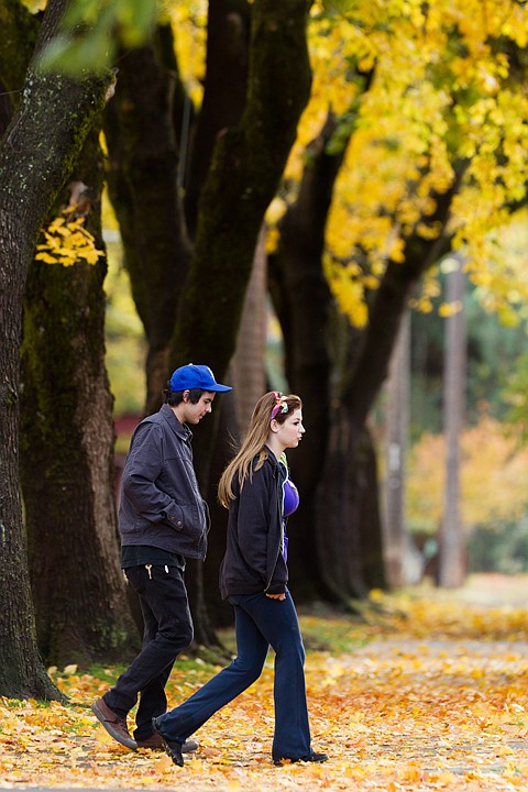 &lt;p&gt;SHAWN GUST/Press Jordan Gillum, left, and Ally Comstock take a scroll under the canopy of fall leaves Monday in Coeur d'Alene.&lt;/p&gt;