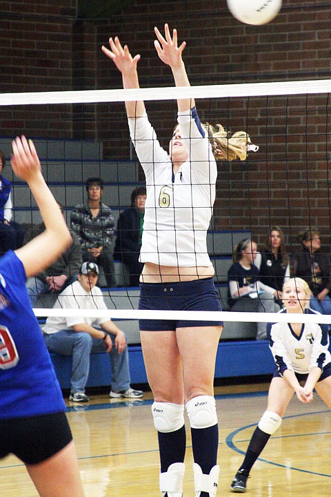 Sophomore Kelsey Fitchett goes up for a block against a hitter from Bigfork.
