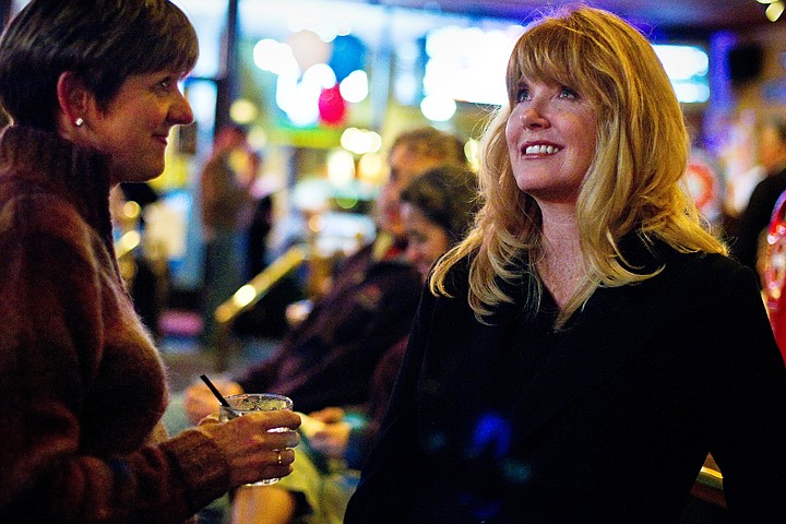 &lt;p&gt;North Idaho College Board of Trustees incumbent, Christie Wood, keeps an eye on the televised national election results while visiting with Sue Thilo during a gathering at Cricket's Steakhouse and Oyster Bar.&lt;/p&gt;