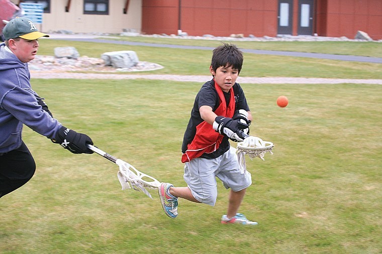 Polson middle schooler Jaryn Tenas learns physics during a game of lacrosse at the NASA camp Saturday.