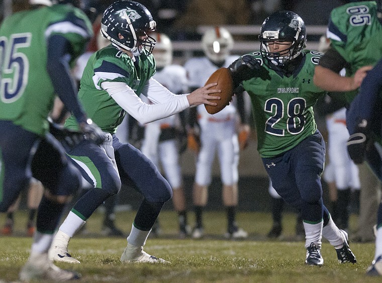 &lt;p&gt;Glacier's junior quarterback Taylor Hulslander (7) hands the
ball off to running back Aaron Mitchell (28) during Glacier's
playoff victory over Billings Senior Friday night at Legends
Stadium.&lt;/p&gt;