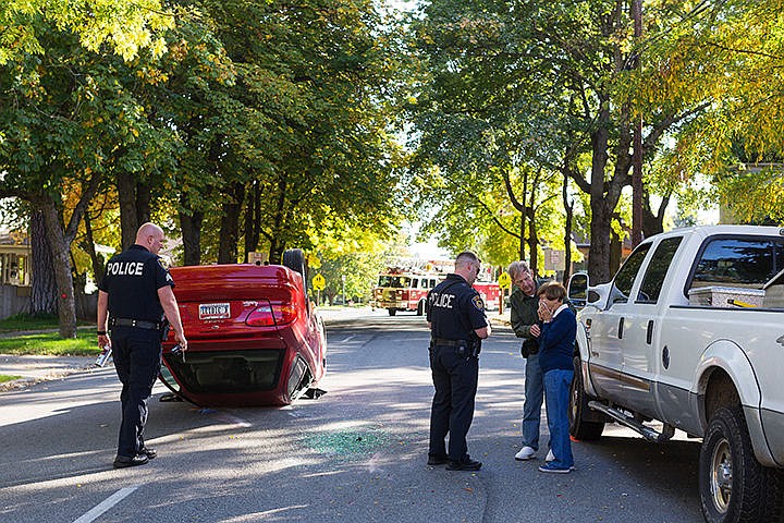 &lt;p&gt;SHAWN GUST/Press&lt;/p&gt;&lt;p&gt;An elderly man comforts his wife as Coeur d&#146;Alene Police officers take statements and begin their investigation of a crash that left a passenger car on its top in the middle of Third Street just north of Foster Avenue after it collided with a parked vehicle trailer Friday in Coeur d&#146;Alene. The couple escaped their sedan with minor injuries.&lt;/p&gt;