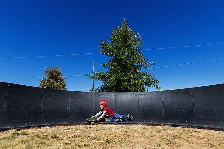 &lt;p&gt;SHAWN GUST/Press&lt;/p&gt;&lt;p&gt;Drew Ranquist, 4, hangs on to his skateboard after losing his balance Monday while practicing his technique on a pump track feature at the Post Falls skate park.&lt;/p&gt;