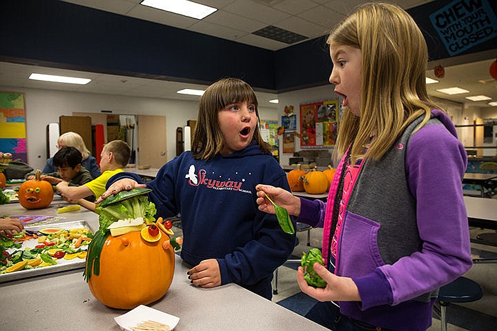 &lt;p&gt;TESS FREEMAN/Press&lt;/p&gt;&lt;p&gt;Fourth graders Makenzie Bigler, left, and Cassie Zaring discover that they can use a watermelon rind as a hat for their pumpkin during a physical education lesson on Wednesday morning. Fourth graders at Skyway Elementary used kitchen scraps to learn about the five categories of fruits and vegetables they should eat on a daily basis.&lt;/p&gt;