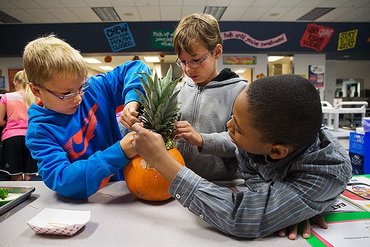 &lt;p&gt;TESS FREEMAN/Press&lt;/p&gt;&lt;p&gt;Fourth graders Dax Larsen, left, Branson Steckman and Corey Stewart use fruits and vegetables from the kitchen to create a pumpkin face during Melissa Giles physical education class at Skyway Elementary School on Wednesday morning.&lt;/p&gt;