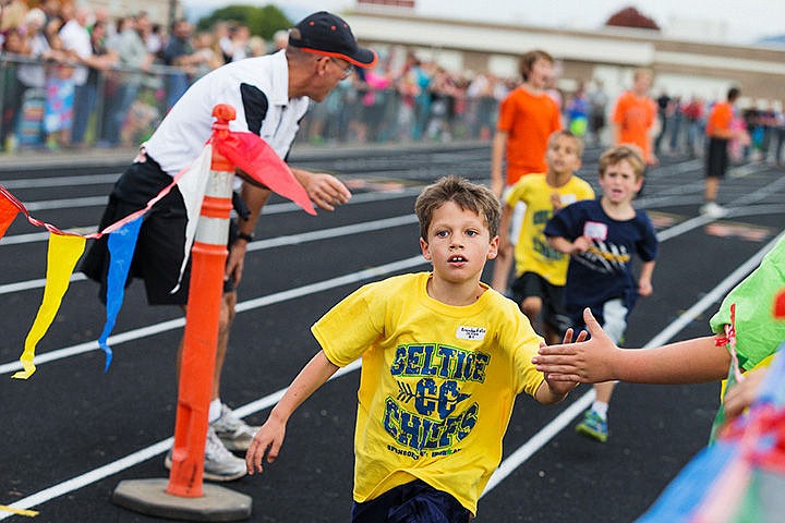 &lt;p&gt;SHAWN GUST/Press&lt;/p&gt;&lt;p&gt;Brtandon Felix, a student at Seltice Elementary, gives a high five just before crossing the finish line in first place of the first grade boys half-mile race.&lt;/p&gt;