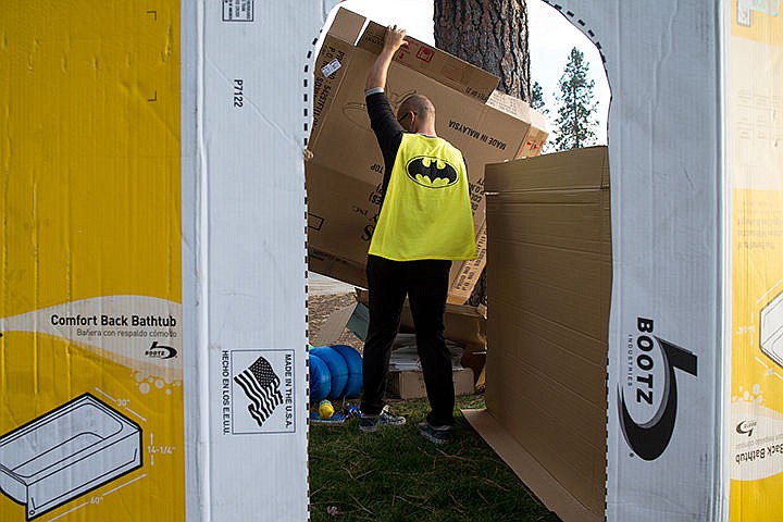 &lt;p&gt;TESS FREEMAN/Press&lt;/p&gt;&lt;p&gt;Josh Mismer puts the fourth wall of his cardboard house in his Batman pajamas at the Cardboard Box City event, a fundraiser for Family Promise in North Idaho. Participants set up their houses on Friday evening and sleep in them overnight.&lt;/p&gt;