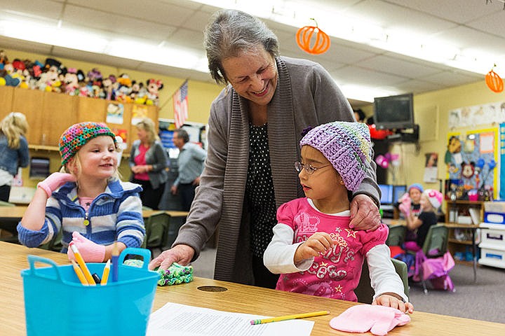 &lt;p&gt;SHAWN GUST/Press&lt;/p&gt;&lt;p&gt;Isabella McPeak, right, and Libby Kennedy react after receiving hats and mittens from Jeannie McDermott during class Monday at John Brown Elementary School in Rathdrum. The Panhandle Happy Hatters, a group of about 40, made more 350 hats while Panhandle State Bank provided a donation of $500 for as many gloves and mittens for the school&#146;s students.&lt;/p&gt;