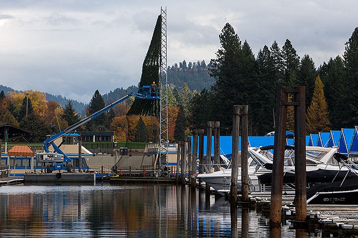 &lt;p&gt;TESS FREEMAN/Press&lt;/p&gt;&lt;p&gt;Kyle Olivier, an engineer for Hagadone, attaches artificial pine boughs to the exterior of a 65-foot-tall floating tree that will be part of the North Pole during the Holiday Lights Cruise this December.&lt;/p&gt;