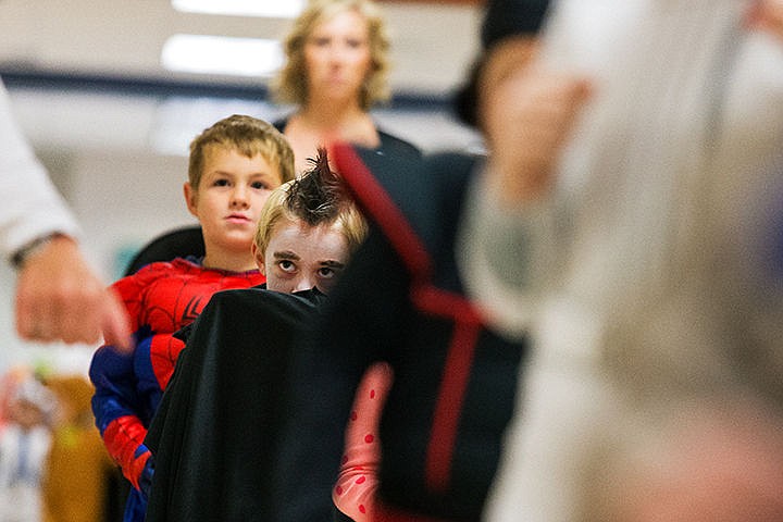 &lt;p&gt;SHAWN GUST/Press&lt;/p&gt;&lt;p&gt;Hayden Adams, a first grade student at Atlas Elementary School, pulls his cape over his mouth in his vampire Halloween costume while walking the hall with class mates as part of a parade Friday in Hayden.&lt;/p&gt;