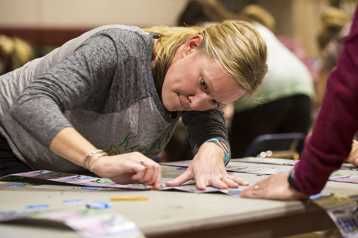 &lt;p&gt;Kootenai Elementary School principal Kelli Knowles scratches a ticket during the first round of Idaho Lottery's Scratch for Schools Wednesday night at North Idaho College.&lt;/p&gt;